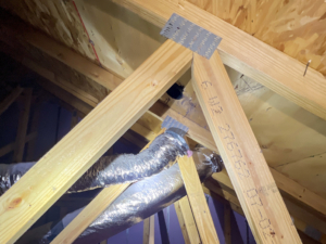 Disconnected dryer vent found in attic during an 11-month New Construction Home Inspection in Jersey at the Enclave at Denville.