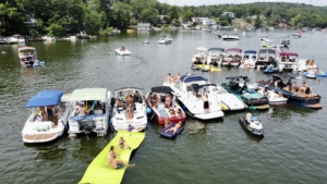 A group of boats tied up together in the shallow waters of Byram Cove on Lake Hopatcong, NJ.