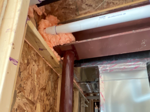 A critical structural defect identified during a pre-drywall inspection at Stone Water Village in Landing, NJ. This load-bearing column was found sitting unfastened to the overhead beam. Without a positive mechanical connection, this column can shift under load, compromising the structural integrity of the floor above.